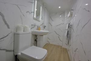 a white bathroom with a toilet and a sink at Oasis, Central Self Contained Flat by CozyNest in Reading +19 photos