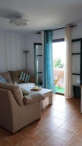 a living room with a couch and a table at Casa LUNA in Frigiliana +13 photos