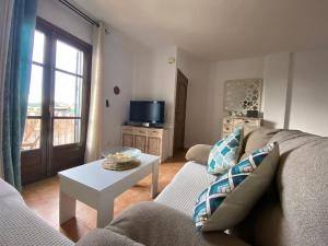 a living room with a couch and a table at Casa LUNA in Frigiliana