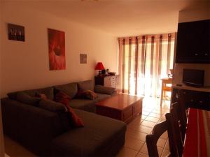 un salon avec un canapé et une table dans l'établissement Appartement T2 Cabine avec Jardin près de Luchon - Pour 6 Pers, Animaux Admis, Parking sécurisé - FR-1-313-142, à Montauban-de-Luchon