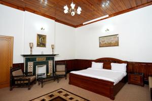 a bedroom with a bed and a fireplace at The Edgeworth in Shimla