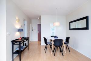 a dining room with a table and chairs in a room at Overlooking the city, bright & cozy - Free Parking (A2) in Reykjavík