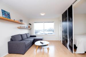 a living room with a couch and a table at Overlooking the city, bright & cozy - Free Parking (A2) in Reykjavík