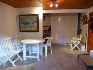 a dining room with a white table and chairs at Chalet cosy 11 pers avec wifi, lave-vaisselle & lave-linge - FR-1-342-229 in Beaufort +6 photos