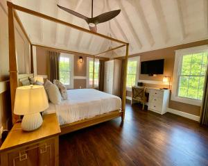 a bedroom with a large bed with a ceiling fan at Weatherills Hotel in Cedar Grove