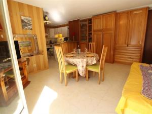 a kitchen with a table and chairs in a room at Appartement Bagnères-de-Luchon, 3 pièces, 7 personnes - FR-1-313-171 in Luchon