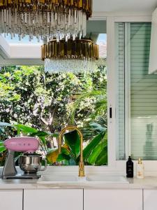 a kitchen sink with a chandelier above a kitchen counter at Tropical Villa in Adeje