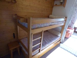 two bunk beds in a cabin with a stool at Studio Saint-Jean-de-Sixt, 1 pièce, 4 personnes - FR-1-458-152 in Saint-Jean-de-Sixt
