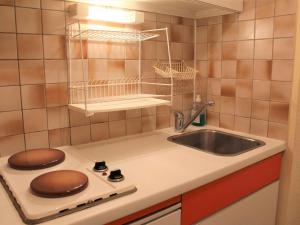 a small kitchen with a sink and a stove at Appartement Vars, 1 pièce, 4 personnes - FR-1-330B-189 in Vars