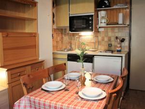 a kitchen with a table with plates and wine glasses at Studio Mezzanine Vars Les Claux, 4 Pers, Proche Commerces - FR-1-330B-192 in Vars