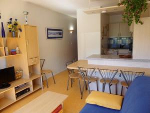 a kitchen and a living room with a table and chairs at Appartement Arette, 2 pièces, 6 personnes - FR-1-602-60 in Arette