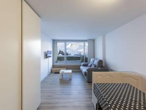 a room with a bed and a couch and a window at Studio cabine 5 pers. avec balcon à 80m des pistes - La Mongie 1800 - FR-1-404-334 in La Mongie