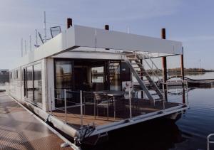ein Haus auf einem Boot auf dem Wasser in der Unterkunft Hausboote am Lankenauer Höft in Bremen