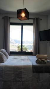 A bed or beds in a room at Mirador De La Axarquia