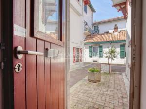 an open door with a view of a street at Appartement Moderne Centre-ville, à Deux Pas de la Plage ! - FR-1-4-619 in Saint-Jean-de-Luz