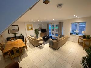 a living room with a couch and a table at School Path Ironbridge Home with Rear Garden in Telford