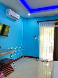 a hospital room with blue walls and a window at Pana Long Beach Resort - SHA Plus in Ko Lanta