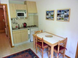 a kitchen with a table and chairs in a kitchen at Appartement Saint-Jean-d'Aulps, 2 pièces, 4 personnes - FR-1-573-35 in Saint-Jean-d'Aulps