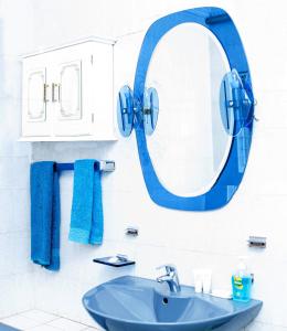a bathroom with a blue mirror and a sink at KINGFISHER PLACE in Lenasia