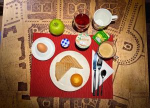 a table with a plate of breakfast food and an apple at Design Hotel 36 in Sofia