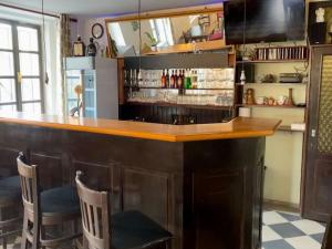 a bar with a wooden counter and some chairs at GASTHAUS SCHLUCKENAU in Šluknov