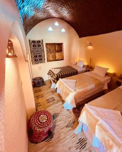 a hotel room with two beds in a room at Aghurmi Siwa Ecolodge & Salt Cave in Siwa