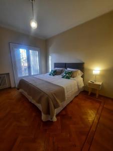 a bedroom with a large bed and a window at La Rufina B&B in Mendoza