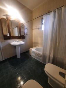 a bathroom with a sink and a tub and a toilet at La Rufina B&B in Mendoza