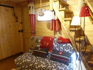 a living room with a couch and a ladder at Charmant Mazot Savoyard à Hauteluce: Idéal pour Couple, Proche Commerces et Ski, Bien Équipé - FR-1-342-263 in Hauteluce