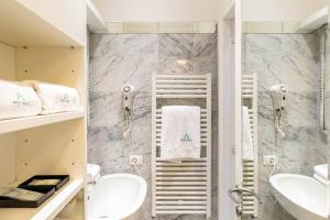 a bathroom with two sinks and a shower at Vittoria Charme in Rome