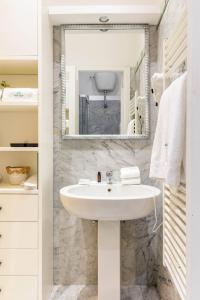 a bathroom with a sink and a mirror at Vittoria Charme in Rome