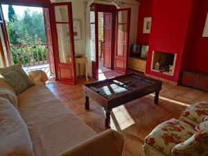 a living room with a couch and a coffee table at Alkyon Villas in Syvota