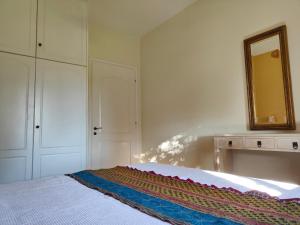 a bedroom with a bed with a mirror and a dresser at Alkyon Villas in Syvota