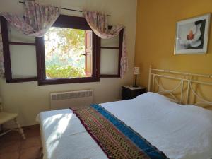 a bedroom with a bed and a window at Alkyon Villas in Syvota