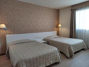 Letto o letti in una camera di Hotel Datini