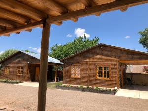 a log cabin with a pavilion in front of it at Entre Viñedos in Ciudad Lujan de Cuyo