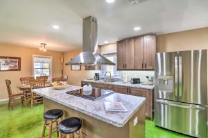 a kitchen with a stainless steel refrigerator freezer at Brand New Cotter Home, Walk to Trout Fishing! in Cotter