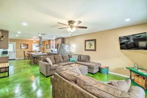 a living room with two couches and a kitchen at Brand New Cotter Home, Walk to Trout Fishing! in Cotter