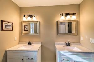 a bathroom with two sinks and two mirrors at Brand New Cotter Home, Walk to Trout Fishing! in Cotter +31 photos