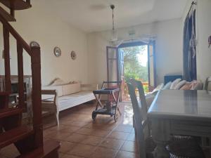 a living room with a couch and a table at Alkyon Villas in Syvota