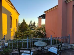 a patio with a table and chairs on a balcony at Alkyon Villas in Syvota