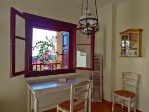 a dining room with a table and a window at Alkyon Villas in Syvota