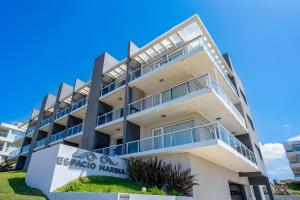 an apartment building with a sign in front of it at Departamento Apart Espacio Marina in Villa Gesell