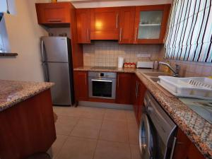 a kitchen with a stainless steel refrigerator and a dishwasher at Escape and relax cozy apartment in Pafos! in Mandria