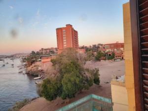 a view of a body of water with a building at Algaafary GeustHouse in Aswan