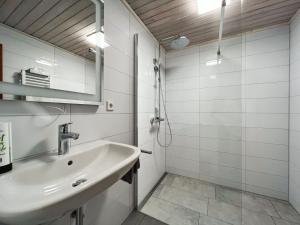 a white bathroom with a sink and a mirror at Hotel Hellers Twenty Four II -24h-Check-In- in Friedrichshafen +59 photos