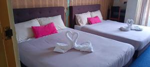 Postel nebo postele na pokoji v ubytování Hotel Tropicanna Pulai Point