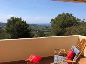 a balcony with two chairs and a view of the mountains at Casa Peppino in Teulada