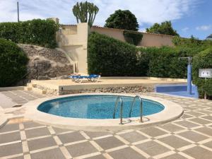a small swimming pool in a yard with a patio at Casa Peppino in Teulada