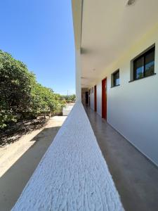 an empty hallway of a house with a sidewalk at Pousada Primavera in Parnaíba
